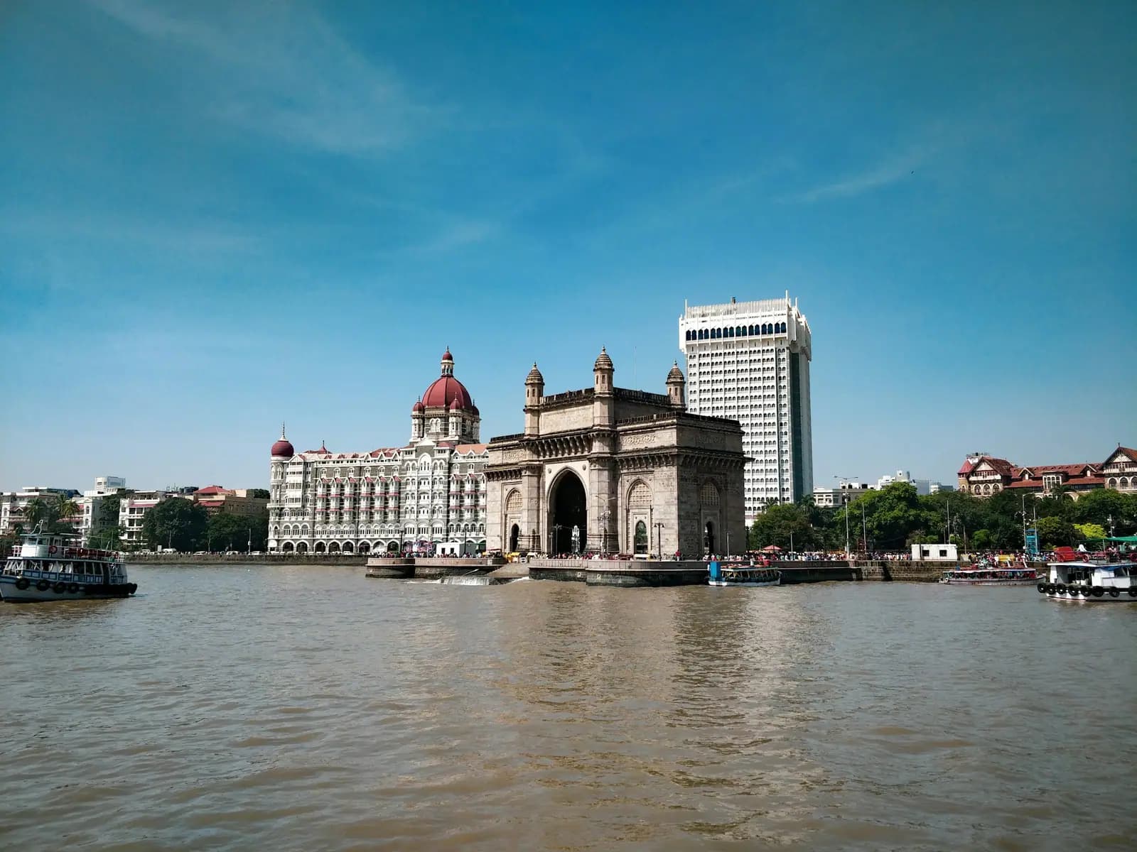 The Gateway of India and the Taj Mahal Palace hotel seen across the water in Mumbai on a clear day